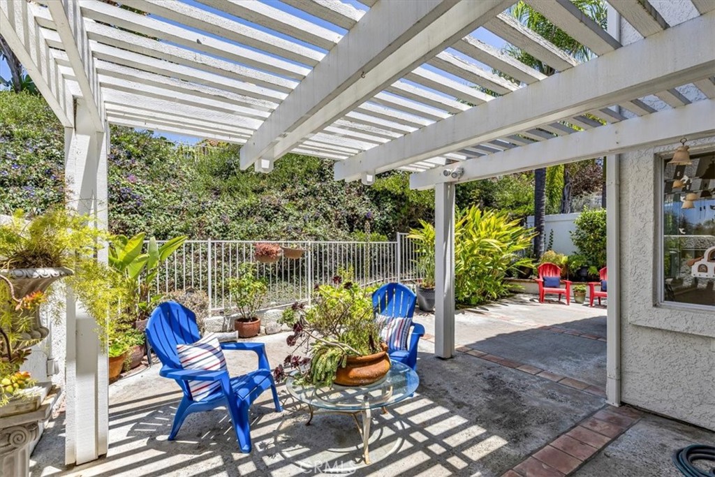 11 Finca San Clemente, CA 92672 - Photo 25 of 55 a view of a patio with a table chairs and a backyard