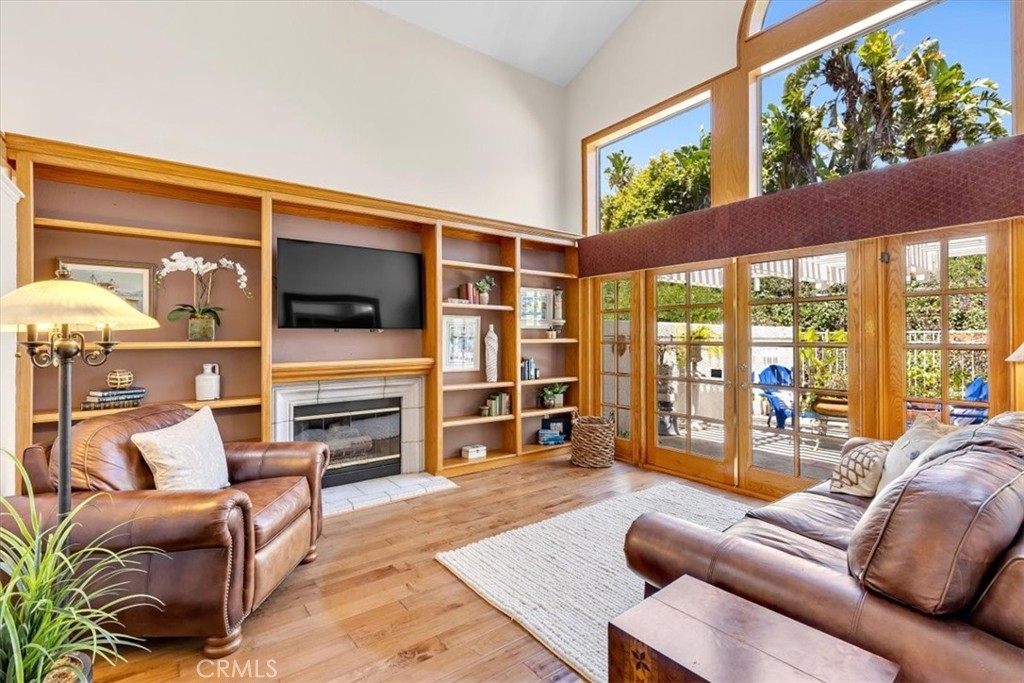 11 Finca San Clemente, CA 92672 - Photo 4 of 55 a living room with furniture a flat screen tv and floor to ceiling window
