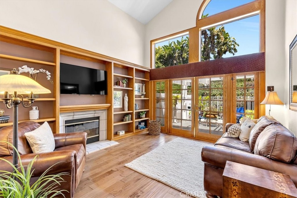 11 Finca San Clemente, CA 92672 - Photo 5 of 55 a living room with furniture a flat screen tv and floor to ceiling window