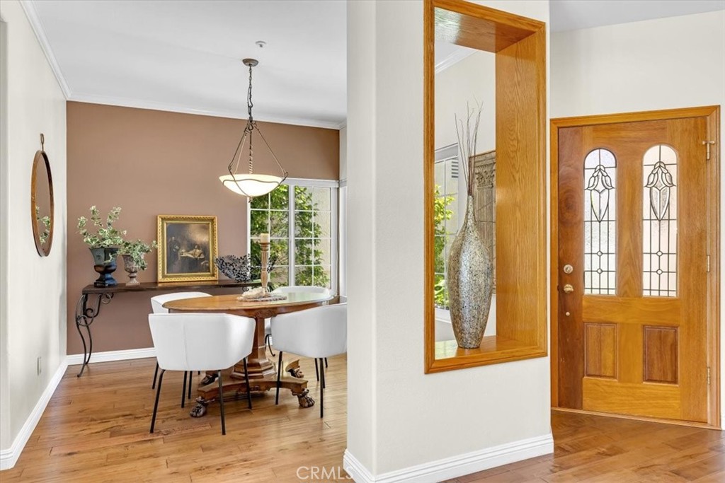 11 Finca San Clemente, CA 92672 - Photo 7 of 55 a dining room with furniture a chandelier and wooden floor