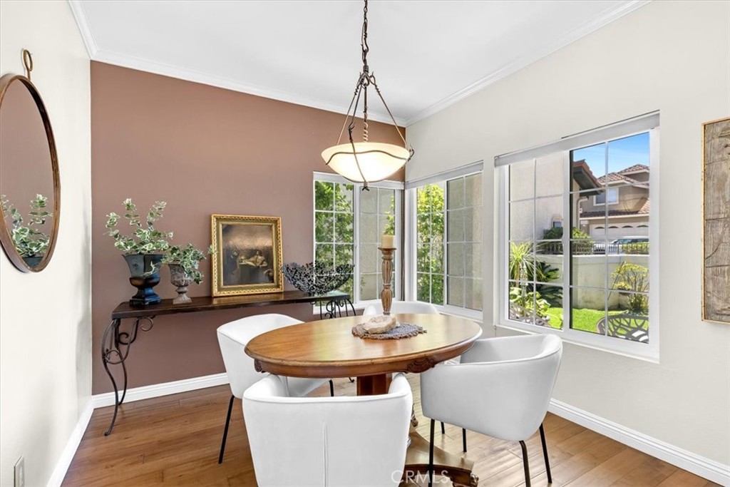 11 Finca San Clemente, CA 92672 - Photo 8 of 55 a dining room with furniture a chandelier and wooden floor