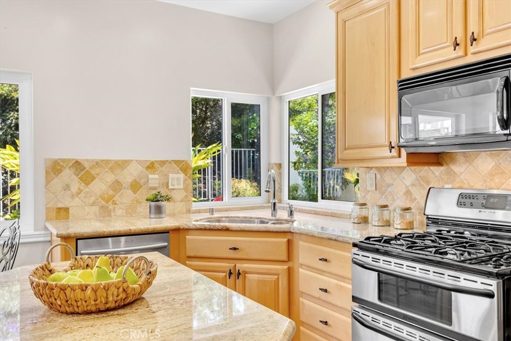11 Finca San Clemente, CA 92672 - Photo 10 of 55 a kitchen with a stove a sink and a cabinets