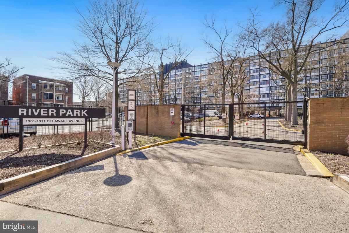 a view of a parking space with wooden fence
