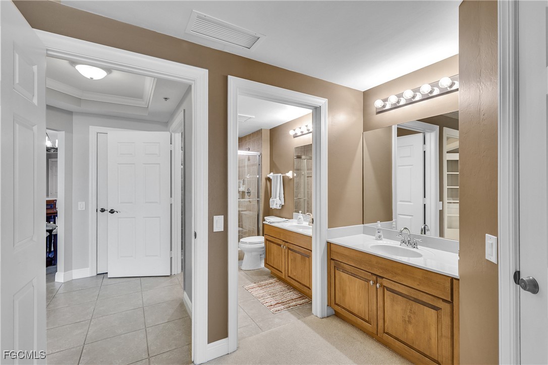 2743 First Street, Unit 1502 Fort Myers, FL 33916 - Photo 23 of 35 a bathroom with a double vanity sink and a mirror