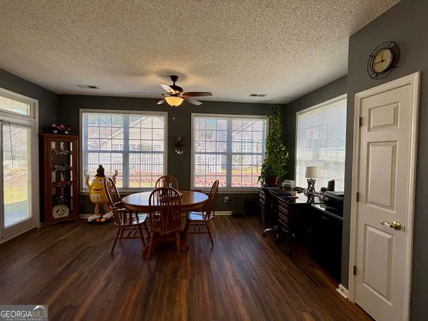 a kitchen with furniture a counter top space stainless steel appliances and wooden floor