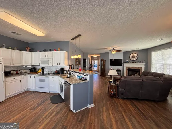 a kitchen with a stove a sink and cabinets