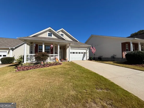 a view of a house with backyard porch and sitting area