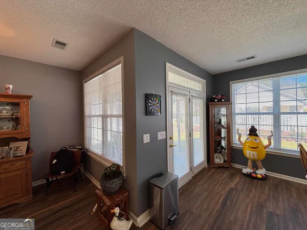 a bedroom with furniture and a flat screen tv