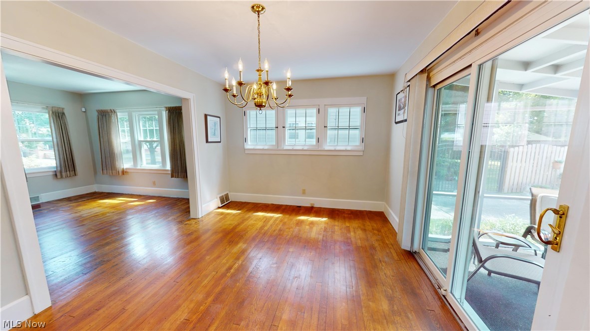 3988 Navahoe Road Cleveland Heights, OH 44121 - Photo 12 of 31 Spare room with hardwood / wood-style floors and a chandelier