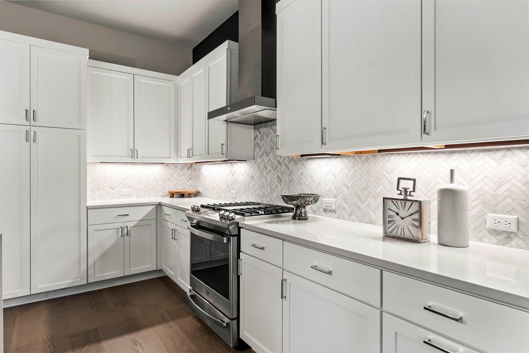 5200 Pink Poppy Pass Austin, TX 78735 - Photo 17 of 38 A herringbone tile backsplash adds a layer of timeless detail to the contemporary kitchen design