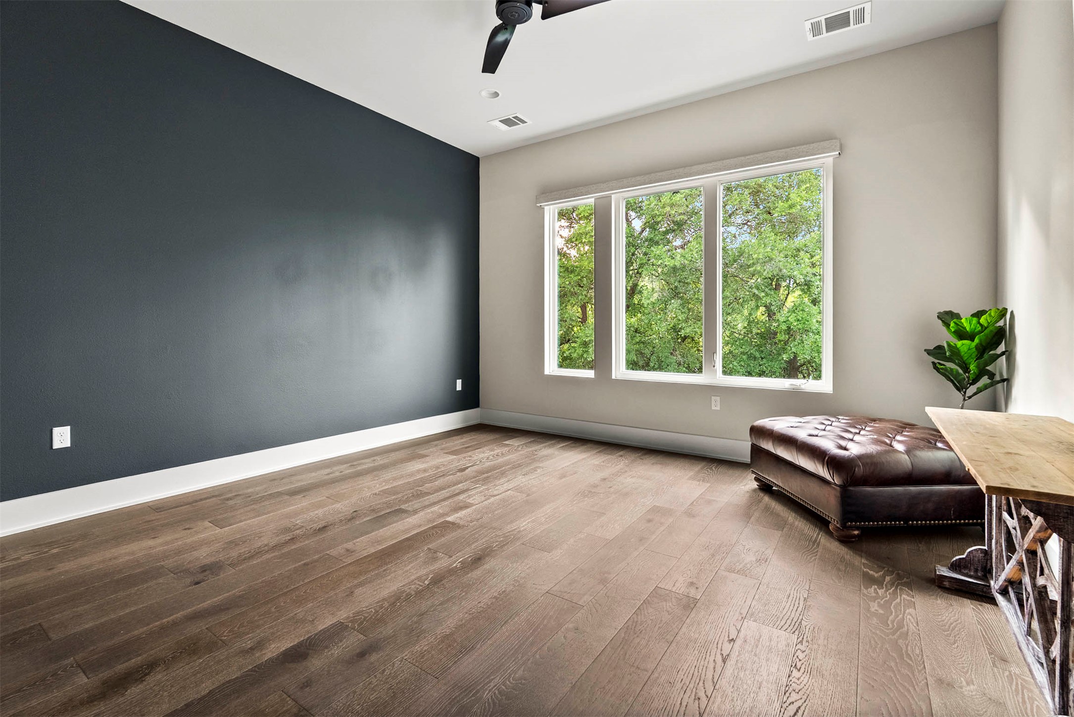 5200 Pink Poppy Pass Austin, TX 78735 - Photo 23 of 38 The primary bedroom is a quiet retreat with large windows that make you feel like you’re staying in a high-end treehouse