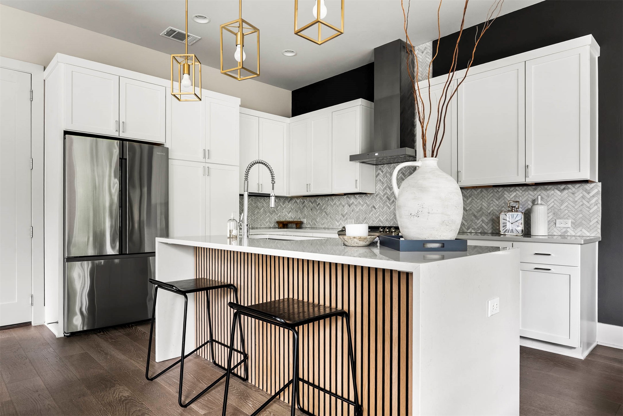 5200 Pink Poppy Pass Austin, TX 78735 - Photo 3 of 38 The same beautiful accent detail from the living room is mirrored on the island, creating a thoughtful, custom look