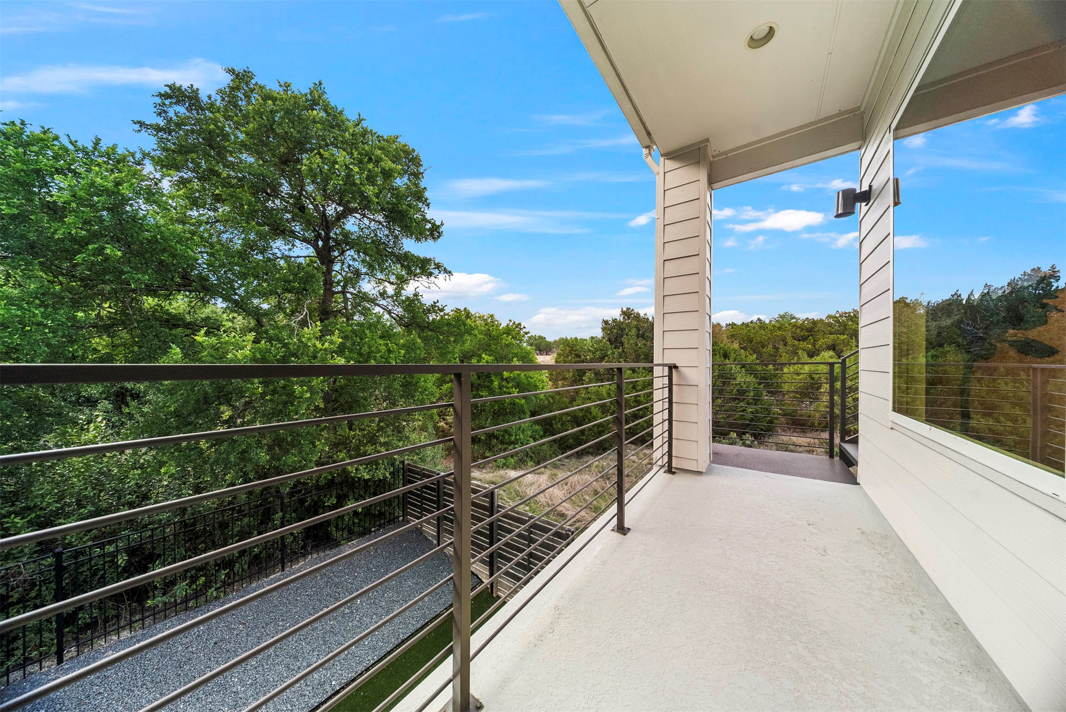 5200 Pink Poppy Pass Austin, TX 78735 - Photo 30 of 38 Step out onto the second-floor balcony for a breath of fresh air and a closer look at the surrounding canopy