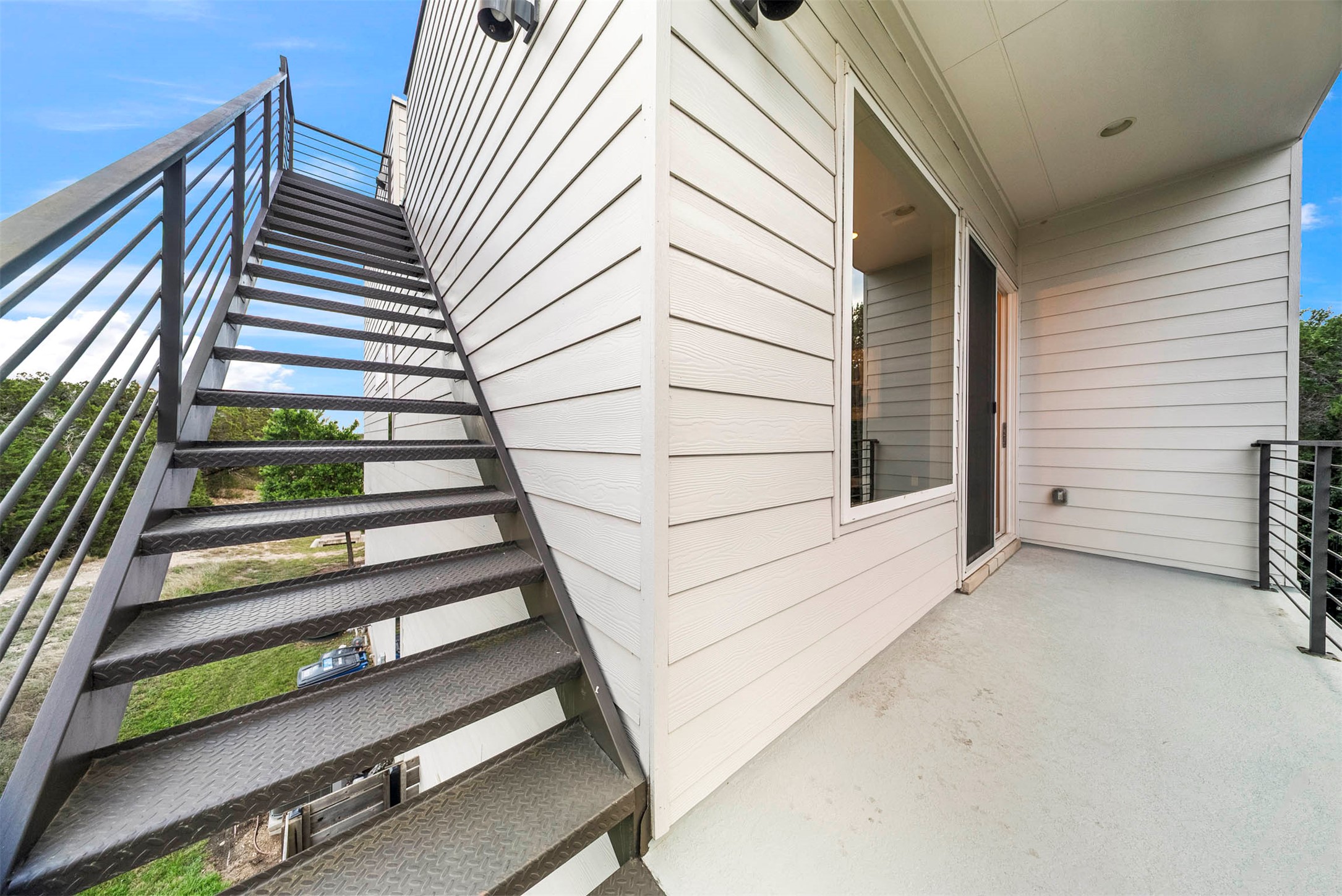 5200 Pink Poppy Pass Austin, TX 78735 - Photo 32 of 38 The back patio is a shaded spot for morning coffee, located just off the dining area and overlooking the turf and xeriscaped yard