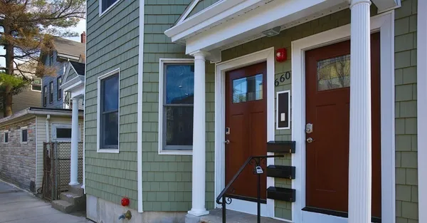 a view of brick house with a large door