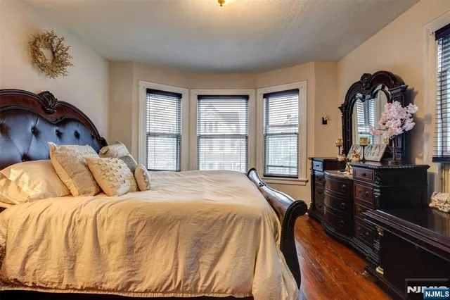 a bedroom with a bed closet and flat screen tv
