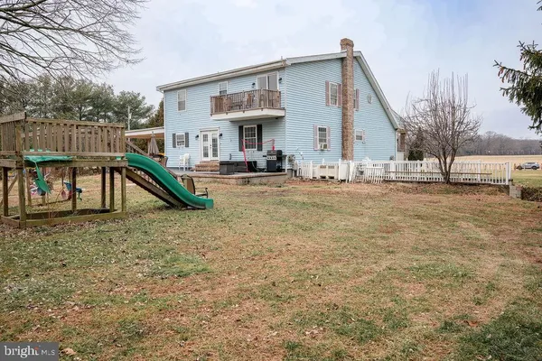 a view of a backyard with a table and chairs and ice snow