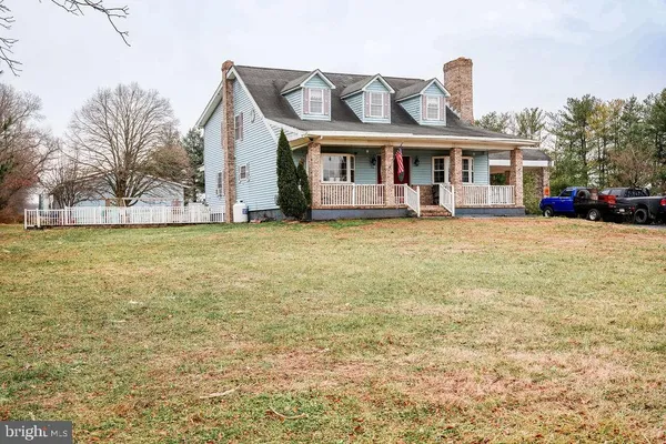 a front view of a house with a garden and porch