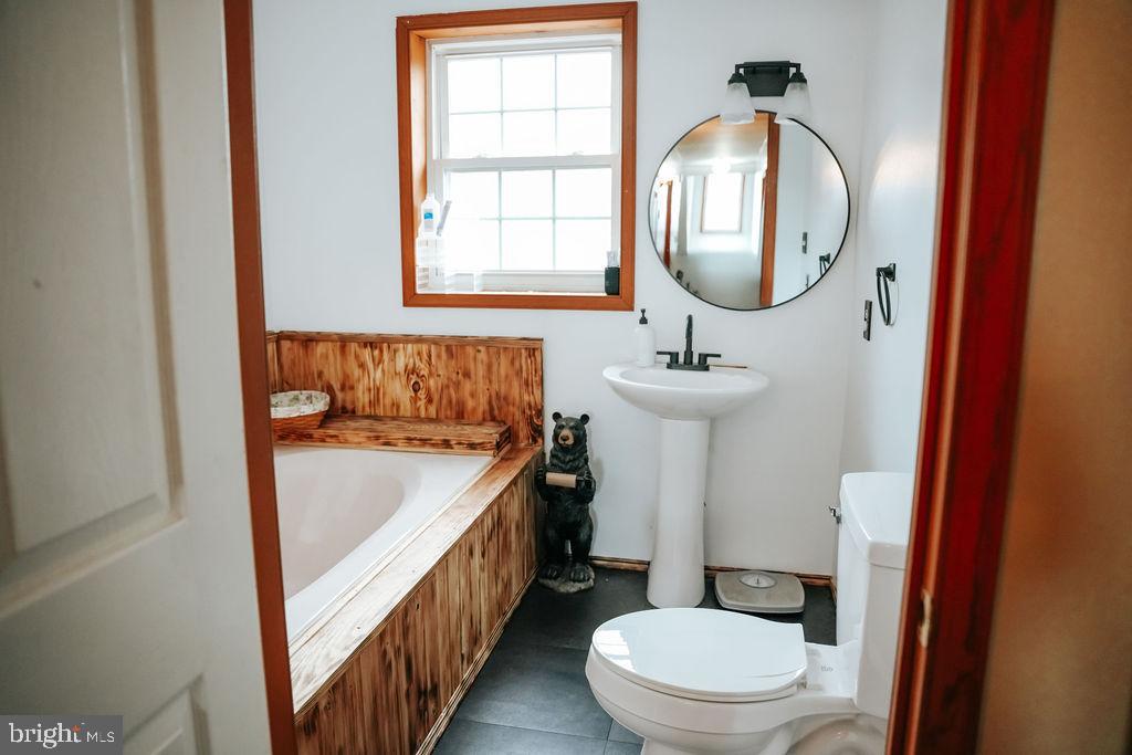 76 Northville Road Bridgeton, NJ 08302 - Photo 46 of 63 a bathroom with a sink toilet and mirror
