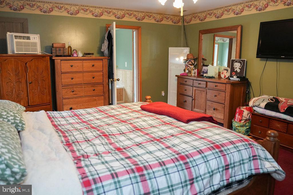 76 Northville Road Bridgeton, NJ 08302 - Photo 49 of 63 a bedroom with a bed and a flat screen tv