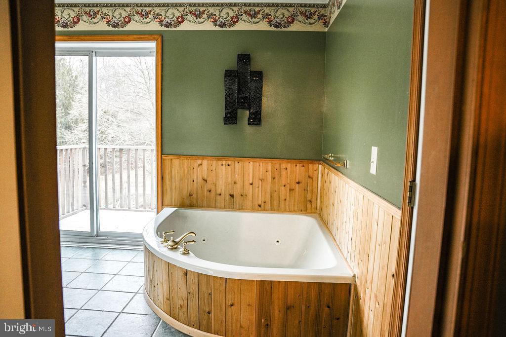 76 Northville Road Bridgeton, NJ 08302 - Photo 50 of 63 a bath tub sitting in a bathroom next to a window
