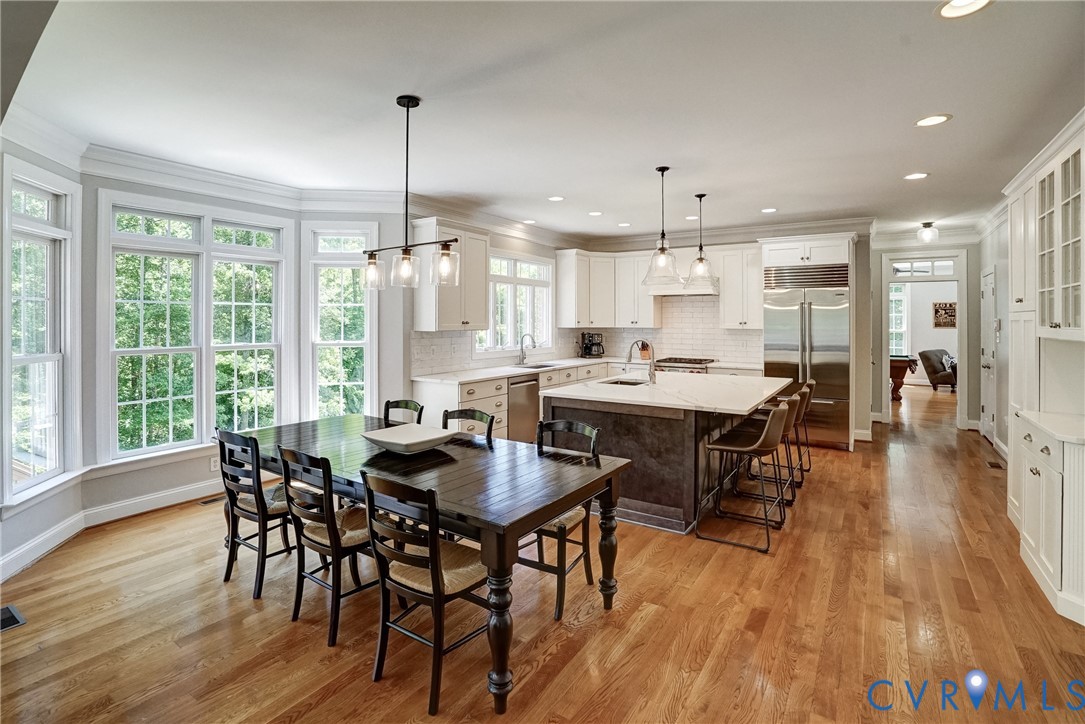 1295 Hermitage Road Manakin-Sabot, VA 23103 - Photo 24 of 55 a dining room with stainless steel appliances granite countertop a dining table chairs and couches chairs