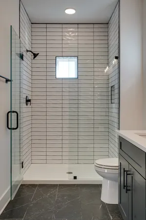 a bathroom with a toilet and a shower