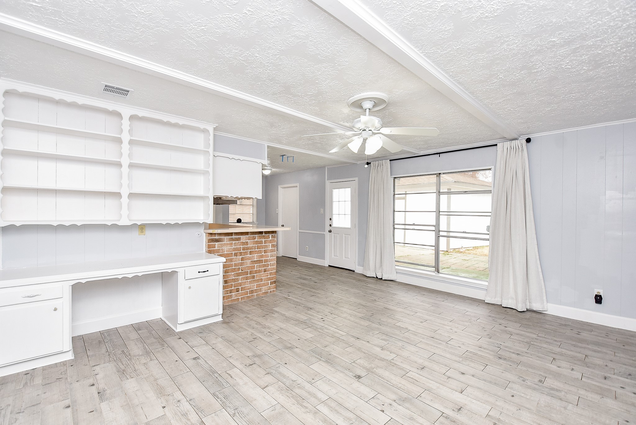 11623 Kirkhollow Drive Houston, TX 77089 - Photo 13 of 32 a view of an empty room with a window and wooden floor