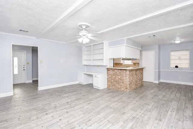 a view of kitchen with cabinets and wooden floor
