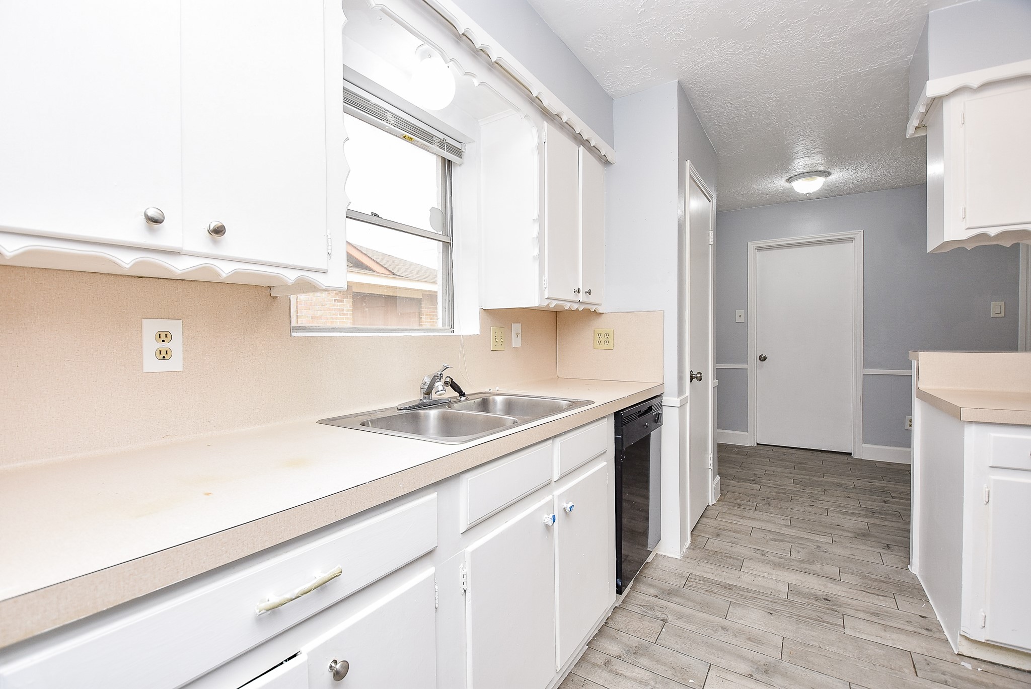 11623 Kirkhollow Drive Houston, TX 77089 - Photo 19 of 32 a kitchen with a sink stove and cabinets