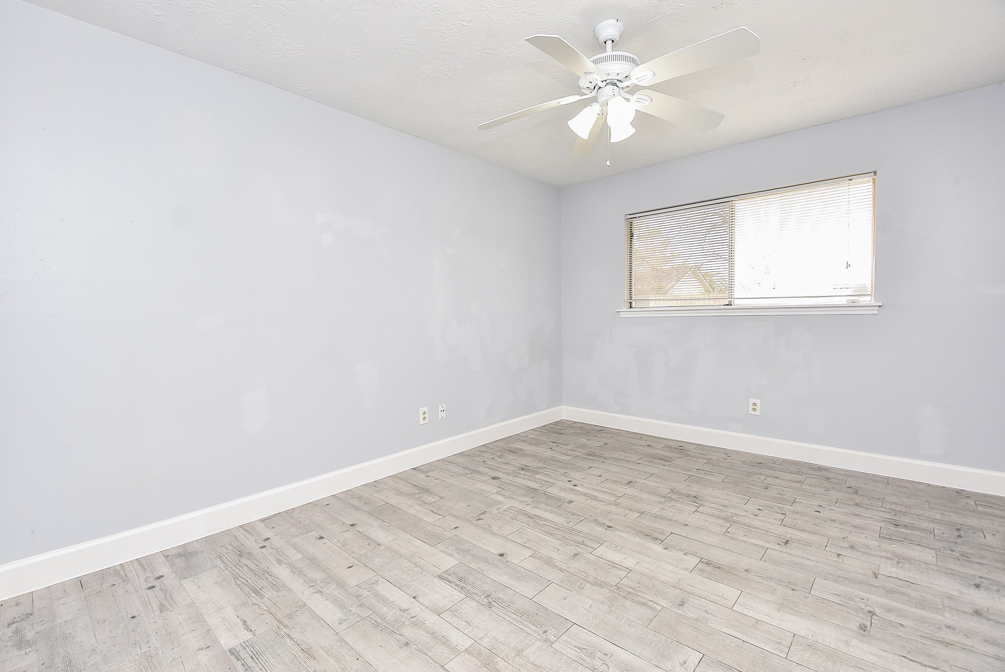 11623 Kirkhollow Drive Houston, TX 77089 - Photo 20 of 32 an empty room with a window and a fan