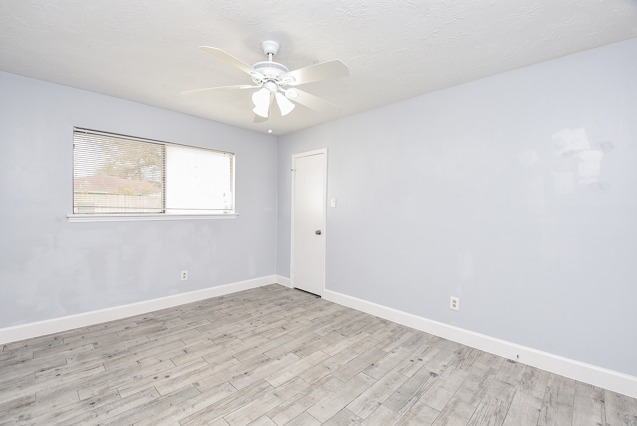 11623 Kirkhollow Drive Houston, TX 77089 - Photo 21 of 32 a view of an empty room with wooden floor and a window
