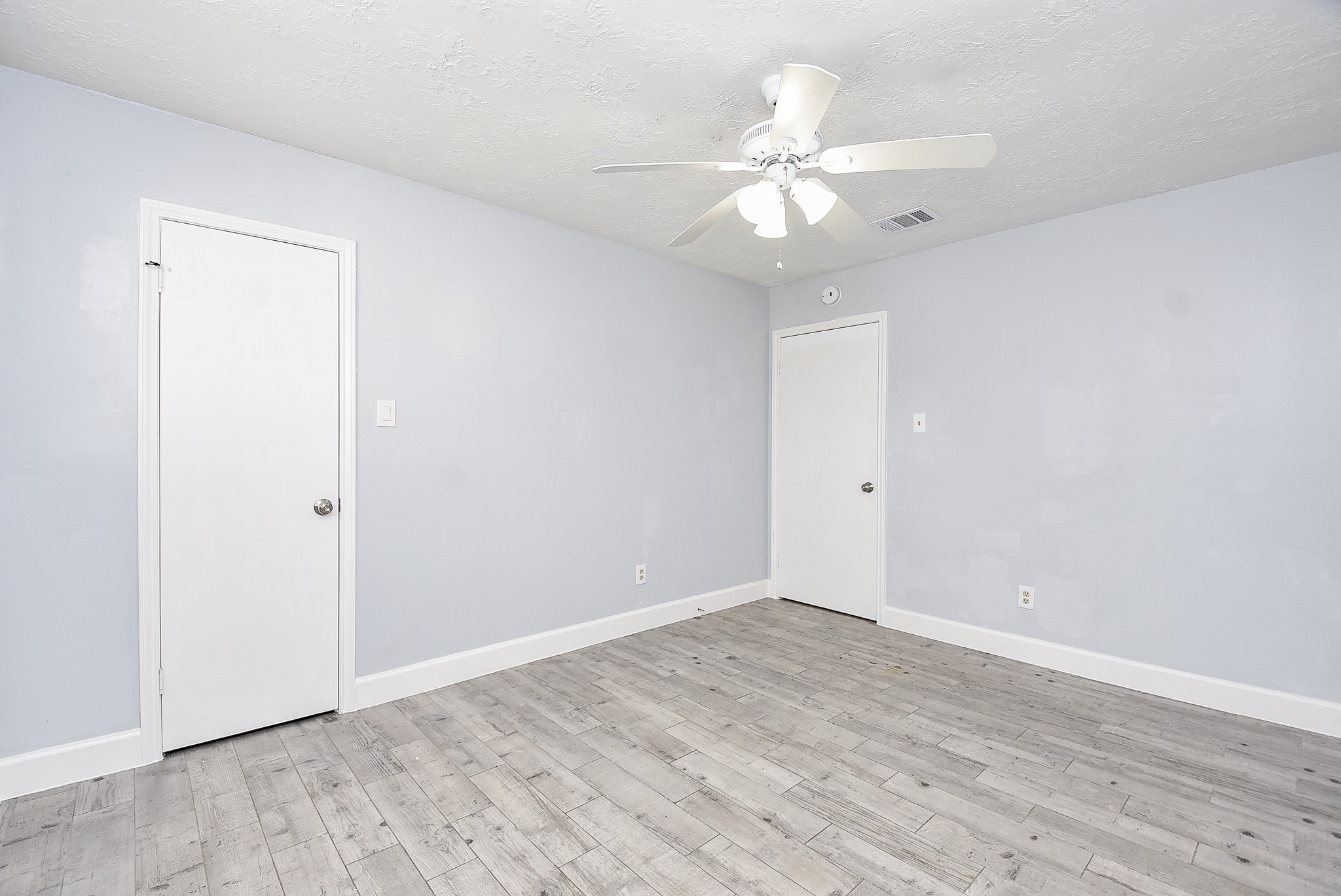 11623 Kirkhollow Drive Houston, TX 77089 - Photo 22 of 32 a view of an empty room with wooden floor
