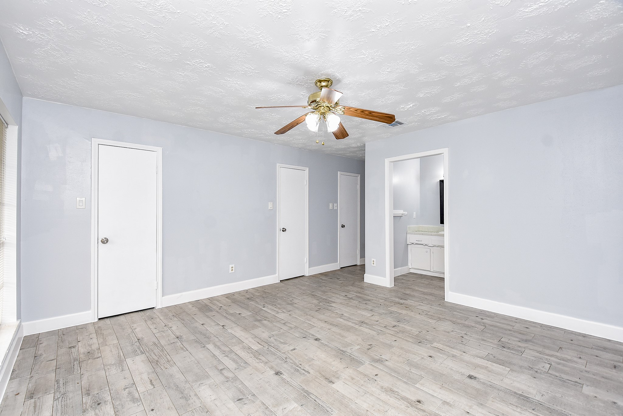 11623 Kirkhollow Drive Houston, TX 77089 - Photo 27 of 32 a view of empty room with wooden floor and ceiling fan