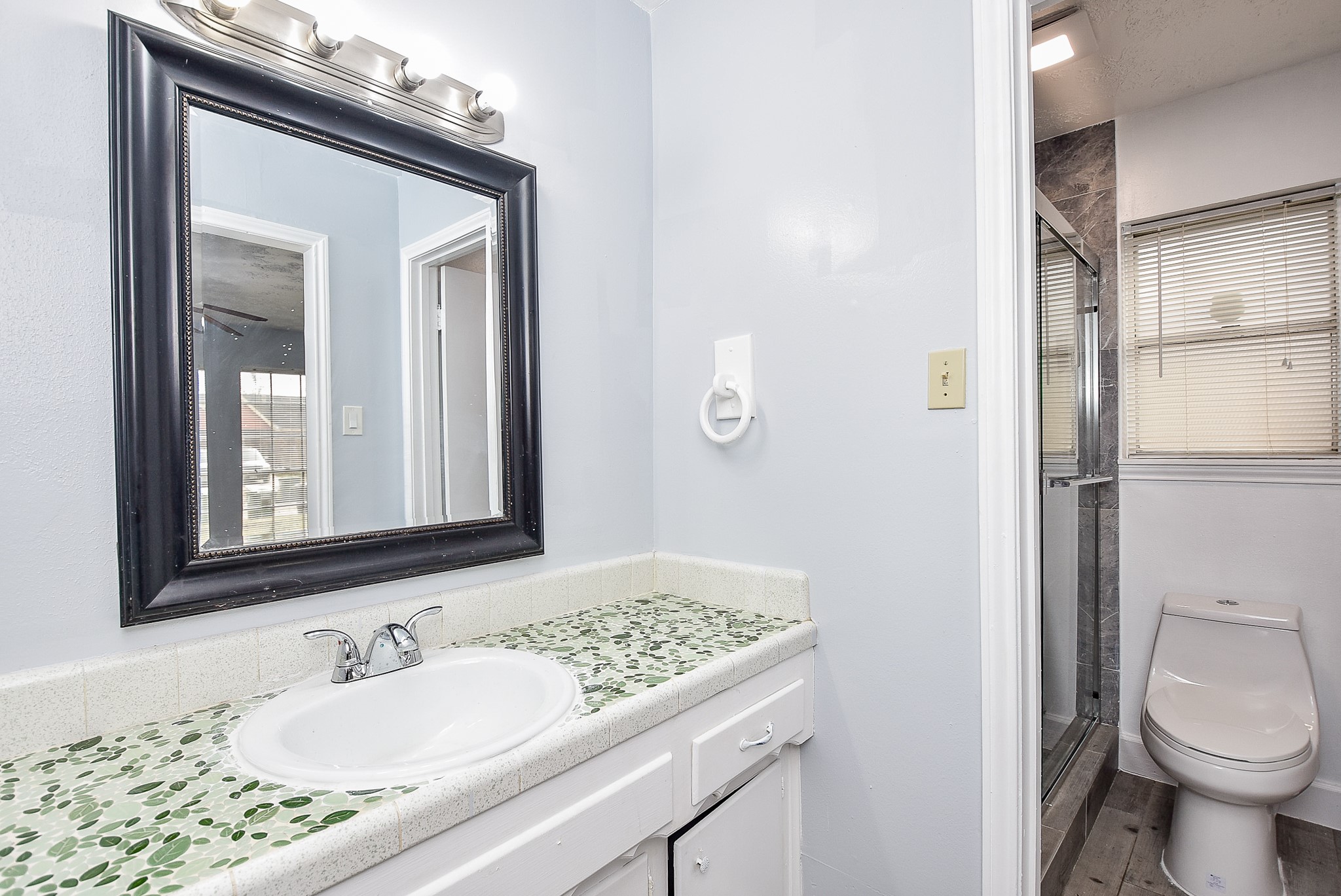 11623 Kirkhollow Drive Houston, TX 77089 - Photo 28 of 32 a bathroom with a granite countertop sink toilet and shower