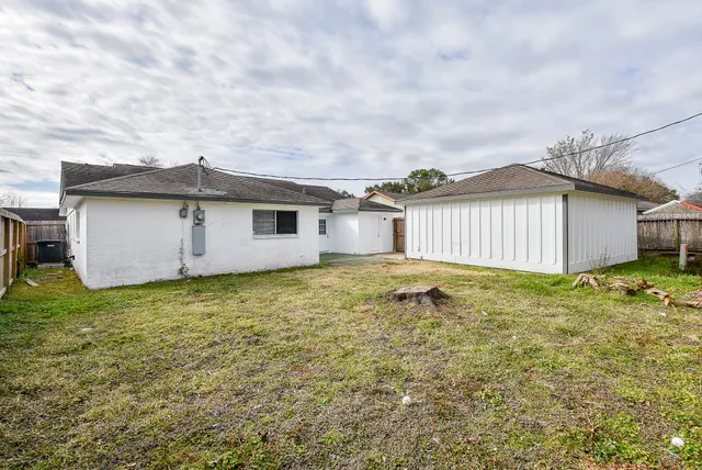 a view of a backyard with a garden and garage