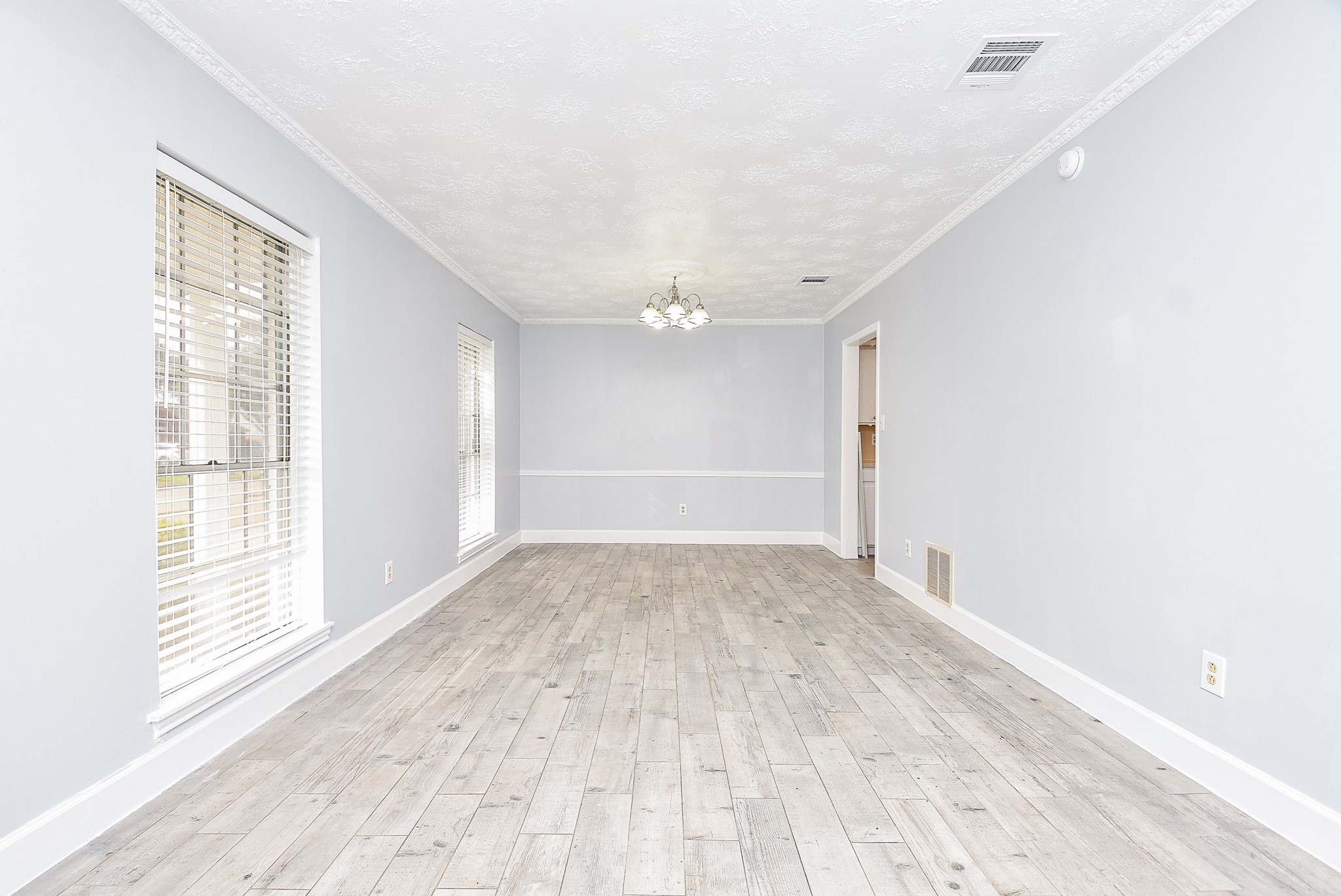 11623 Kirkhollow Drive Houston, TX 77089 - Photo 9 of 32 a view of empty room with wooden floor and fan