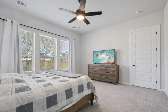 a bedroom with a bed and a window