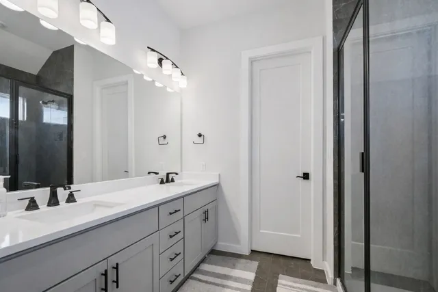 a bathroom with a double vanity sink mirror and double