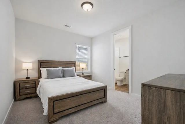 a bedroom with a bed and a night stand