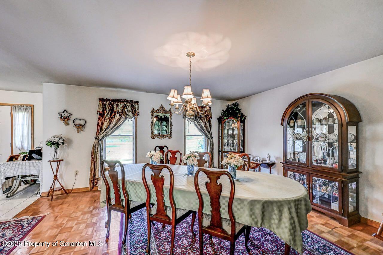 314 Reynolds Road Factoryville, PA 18419 - Photo 13 of 58 a view of a dining room with furniture and a chandelier