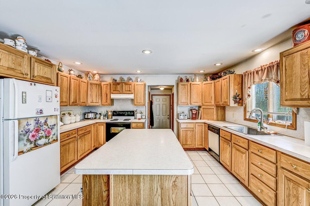 314 Reynolds Road Factoryville, PA 18419 - Photo 21 of 58 a large kitchen with stainless steel appliances lots of counter space and wooden floor