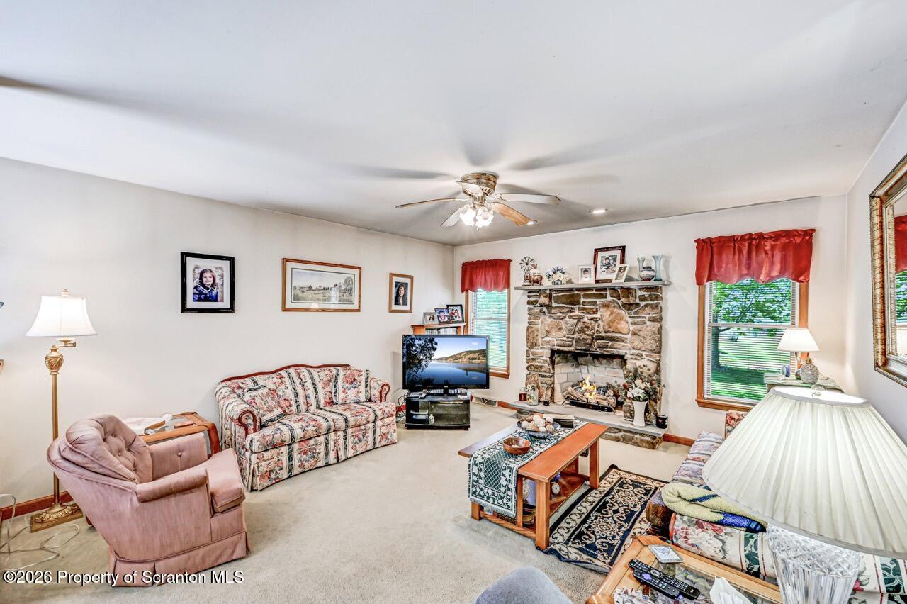 314 Reynolds Road Factoryville, PA 18419 - Photo 22 of 58 a living room with furniture a couch and two large window