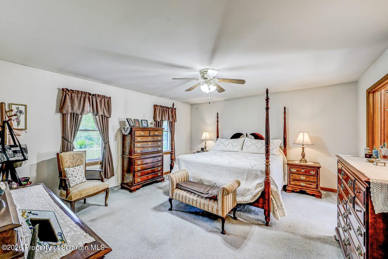 314 Reynolds Road Factoryville, PA 18419 - Photo 27 of 58 a bedroom with furniture and a chandelier