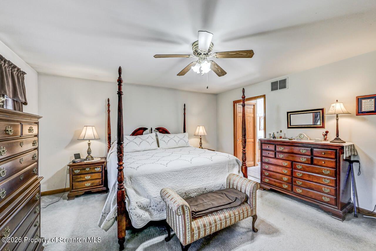 314 Reynolds Road Factoryville, PA 18419 - Photo 28 of 58 a bedroom with a bed chandelier and a window