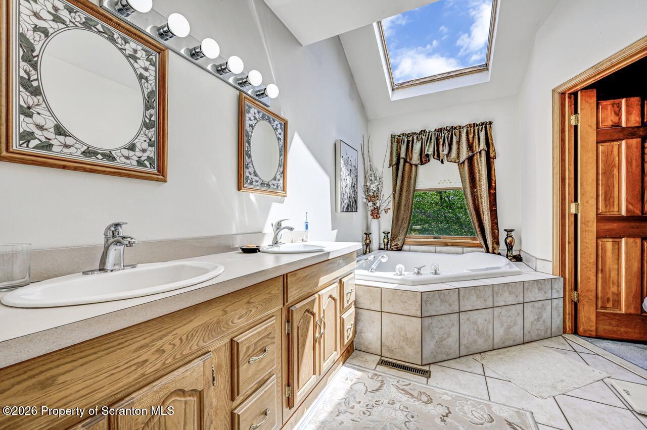 314 Reynolds Road Factoryville, PA 18419 - Photo 31 of 58 a bath room with a sink mirror and a bathtub