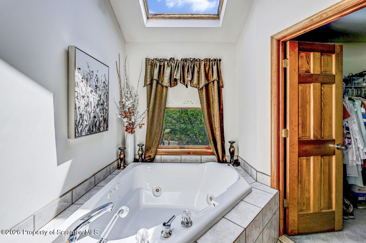 314 Reynolds Road Factoryville, PA 18419 - Photo 32 of 58 a bathroom with a bathtub and a window