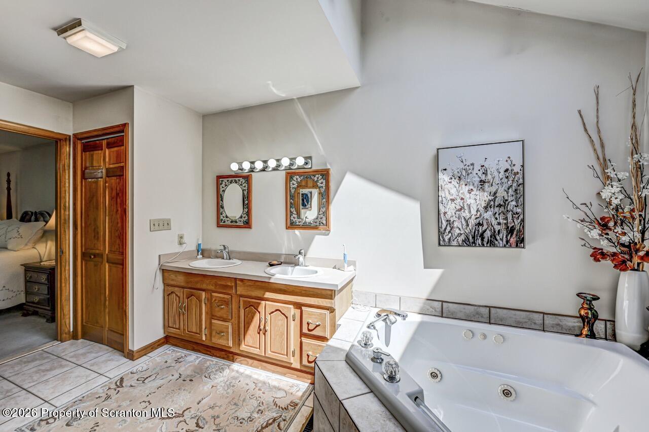 314 Reynolds Road Factoryville, PA 18419 - Photo 35 of 58 a spacious bathroom with a tub sink and mirror