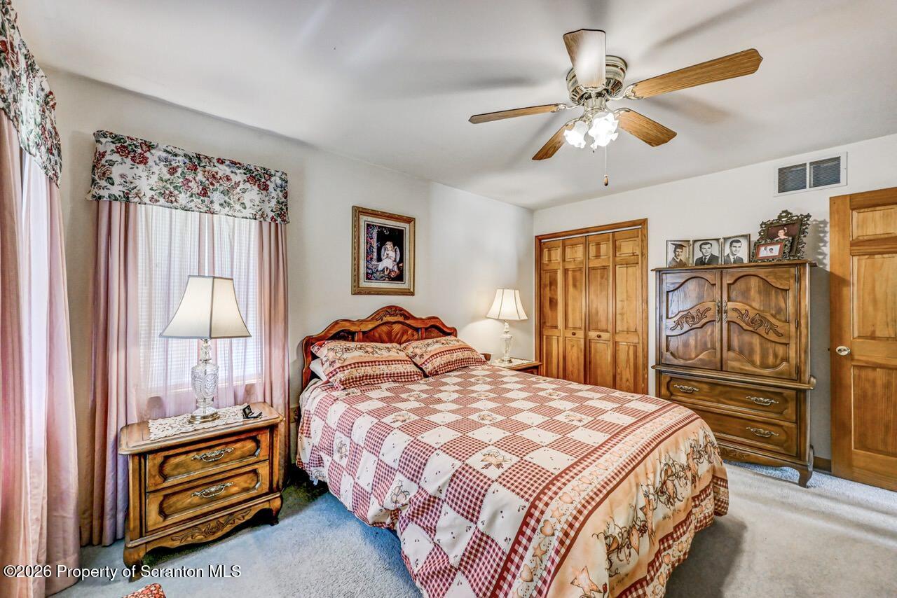 314 Reynolds Road Factoryville, PA 18419 - Photo 37 of 58 a bedroom with a bed and a chandelier