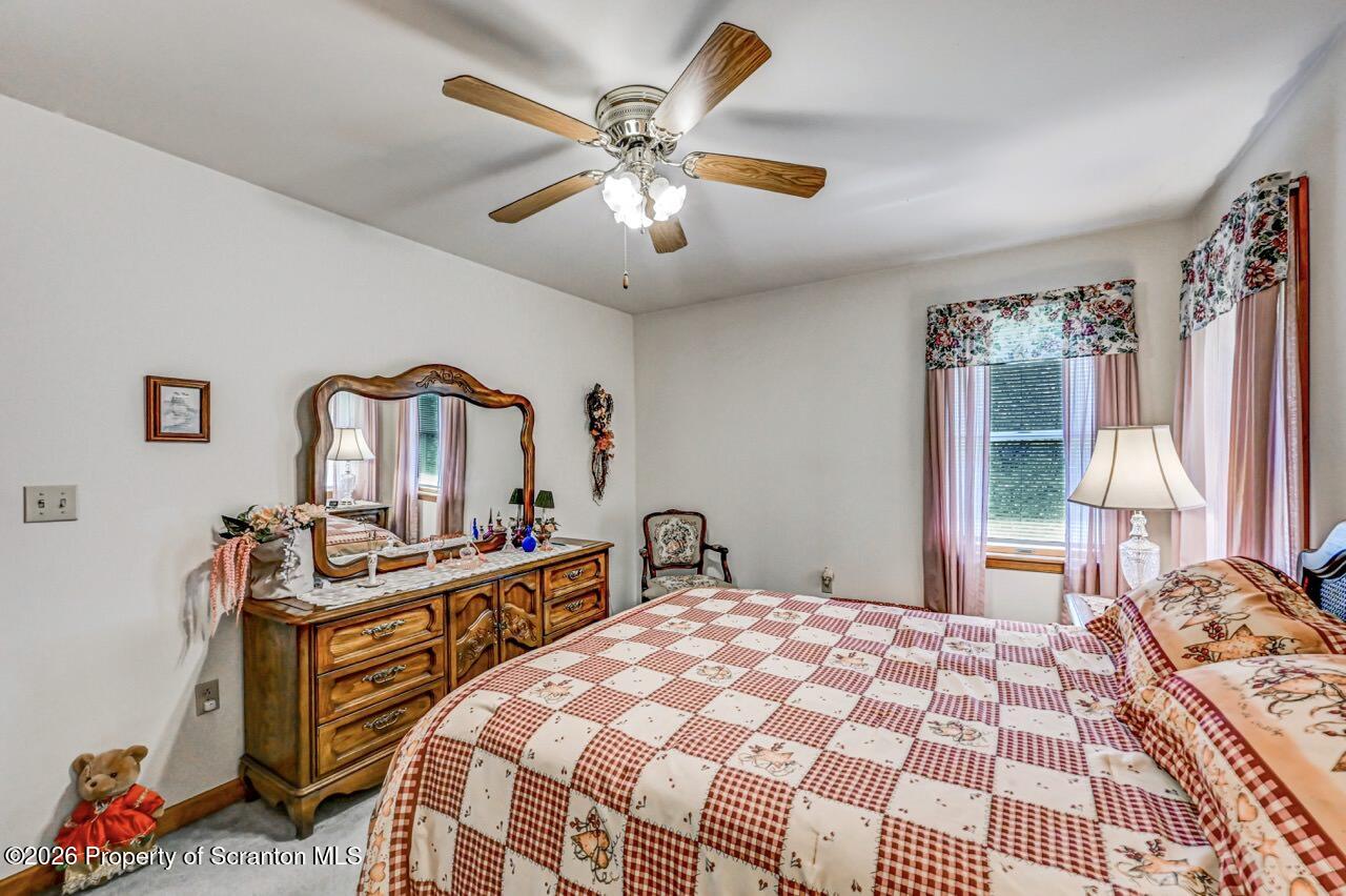 314 Reynolds Road Factoryville, PA 18419 - Photo 38 of 58 a bedroom with a bed and wooden floor